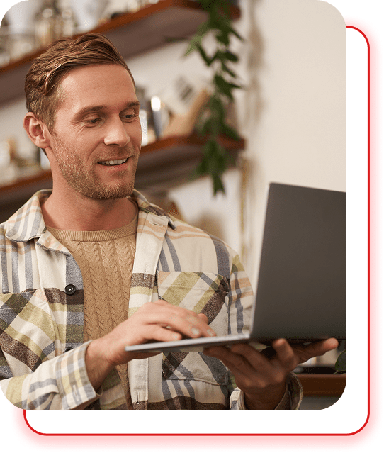 Smiling man working on a laptop