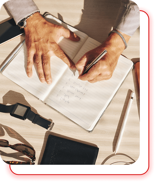 Hands reviewing a printed manuscript with a pen