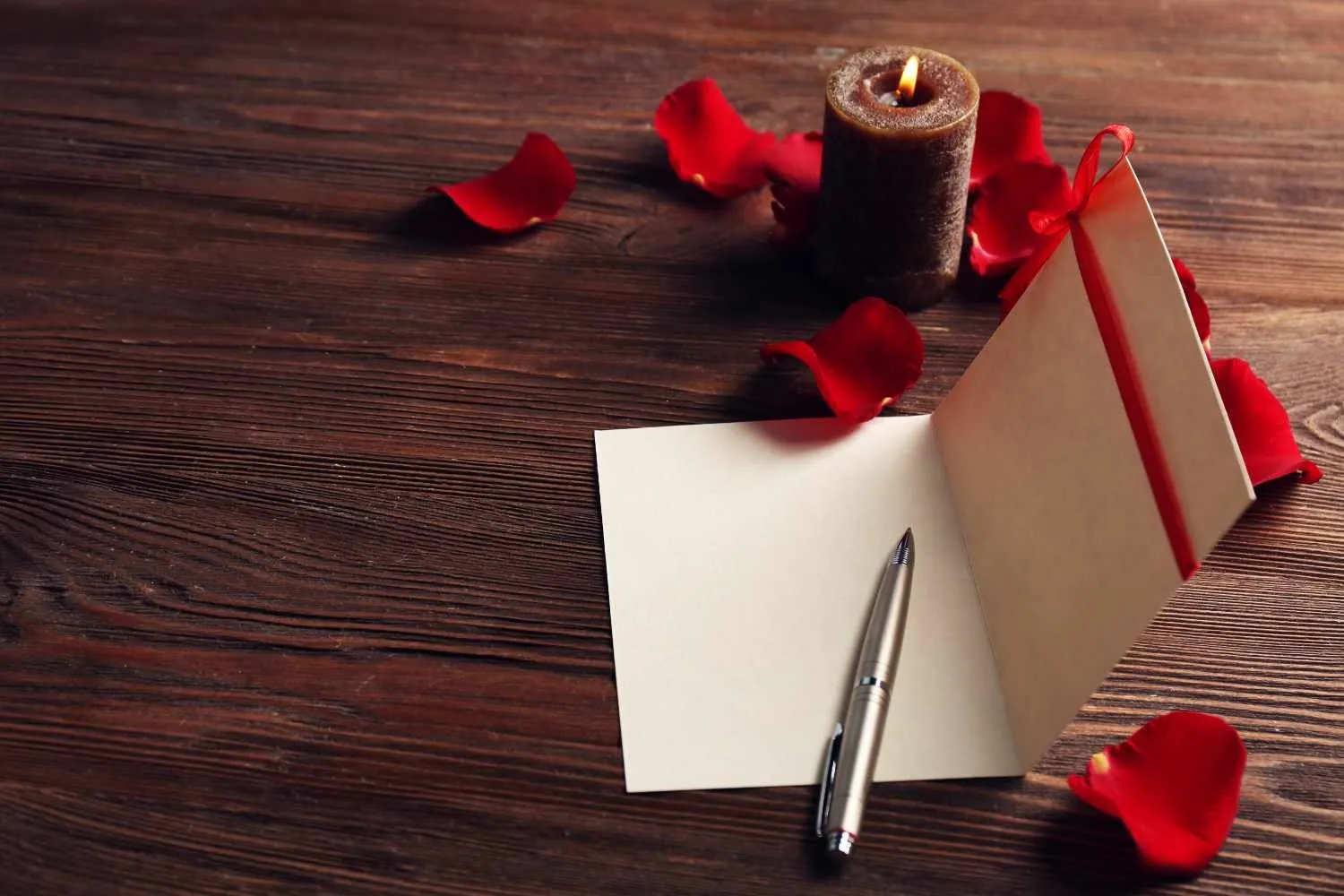 gift-card-valentine-s-day-with-pen-red-petals-candle-wooden-background