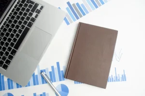 laptop-computer-with-blank-notepad-pen-white-desktop-high-quality-photo