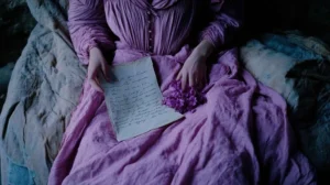 woman-reads-antique-letter-lilac-blossoms-vintage-dress-dark-room-romantic-mood