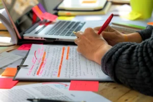 editor-marking-corrections-printed-manuscript-red-pen-postit-notes-hand canadianghostwriters