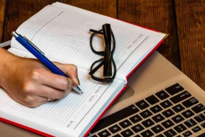 hands-woman-with-diary-eyeglasses-laptop canadianghostwriters