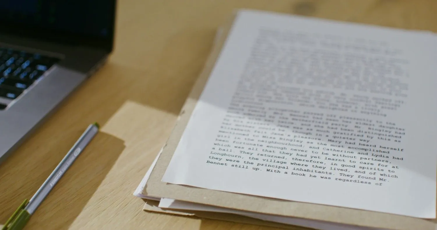 man-turns-leaf-book-sitting-table-closeup canadianghostwriters